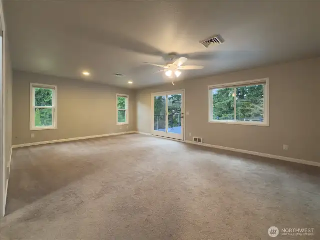 Primary suite with slider out to the deck that overlooks the private backyard.