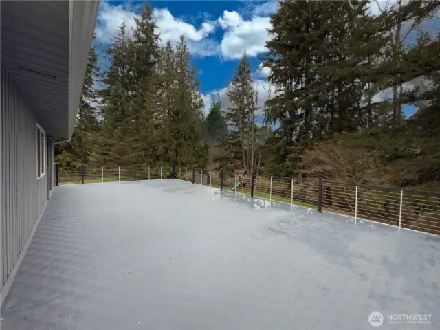 Deck off the primary suite overlooking the private backyard.