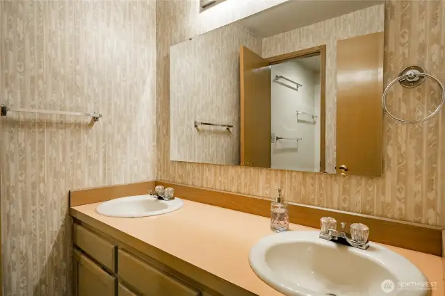 Full bath with double sinks and privacy closet for the tub/shower and toilet