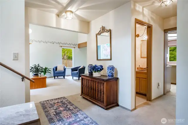 From entry looking towards living and dining room, stairway on the left and kitchen, family room, 1/2 bath, laundry down the hall to the right