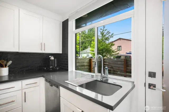 Quartz countertops and an undermount sink.