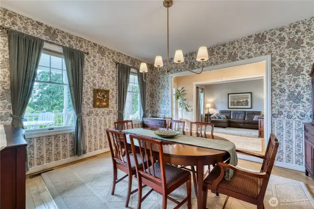 View of dining room next to front entrance and looking into Family room.