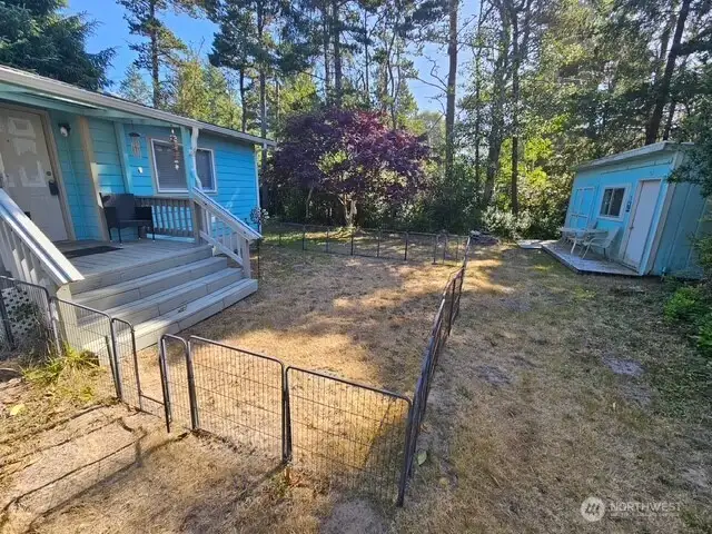 Home entrance to the left and ADU and storage shed to the right.