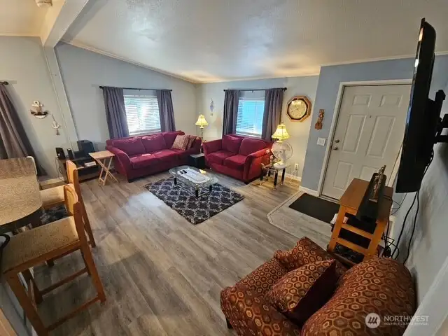 Living room opens into the dining area and kitchen.