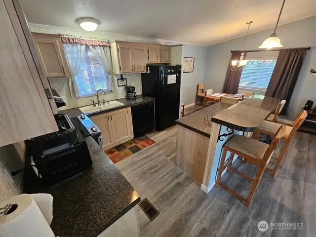 Plenty of counter space and a great bar with stools.