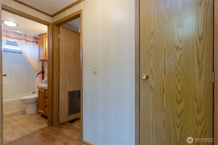 Hall leading to guest bath and laundry area