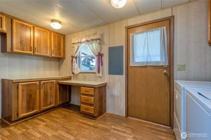 Laundry room with desk and extra storage.