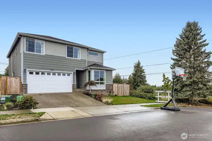 Street view of home with attached garage and driveway.