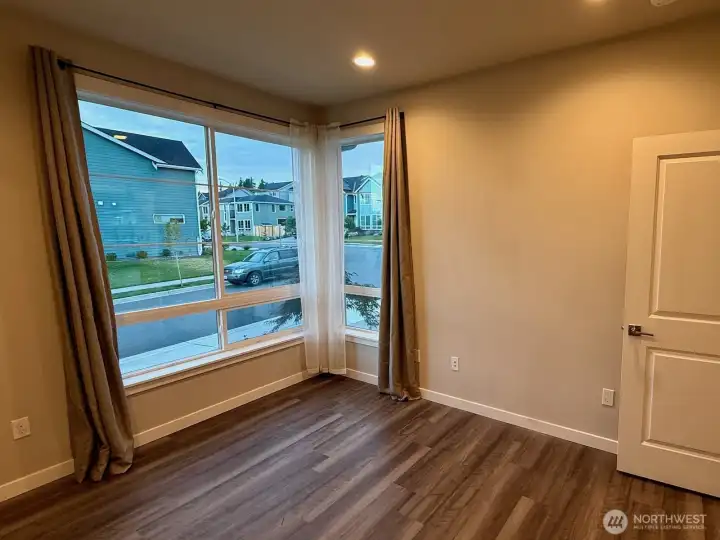 Downstairs front bedroom or office with natural light and flexible layout.