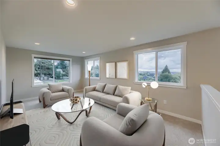 A virtual staging of the upstairs rec room with sunset views to the Olypmic Mountains.