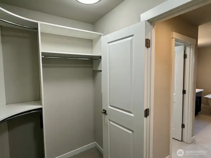Primary bedroom walk-in closet with ample storage and organization space.