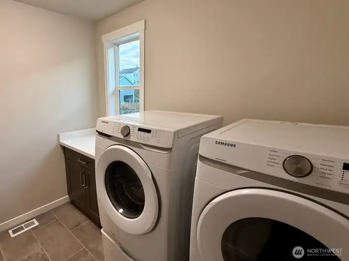 A beautiful set of laundry machines and a folding station rounds out the upstairs.