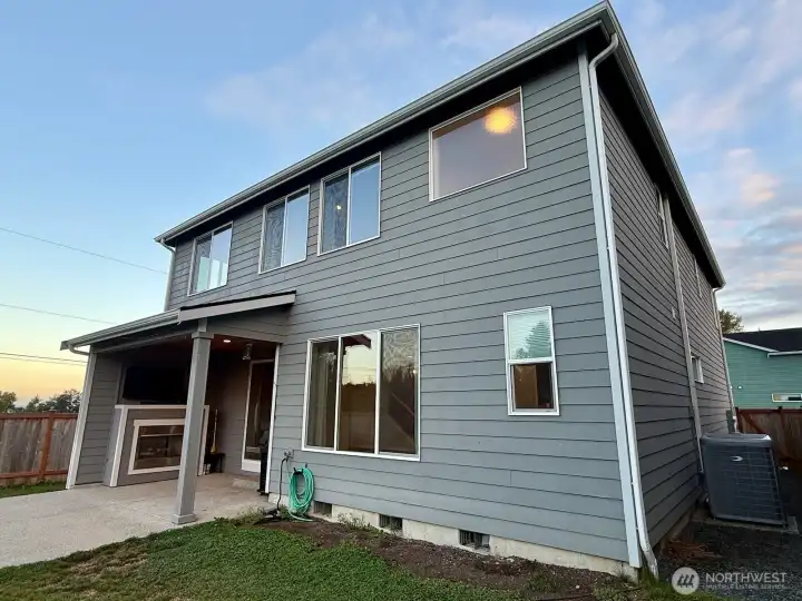 A stunning home with a patio fireplace and amazing sunset views.