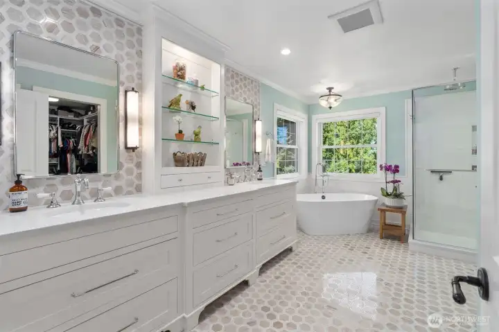 Luxurious bathroom with Limestone marble floors, Quartz countertops, Italian Rohl faucets, and Victoria & Albert tub, and walk-in closet from California Closets.
