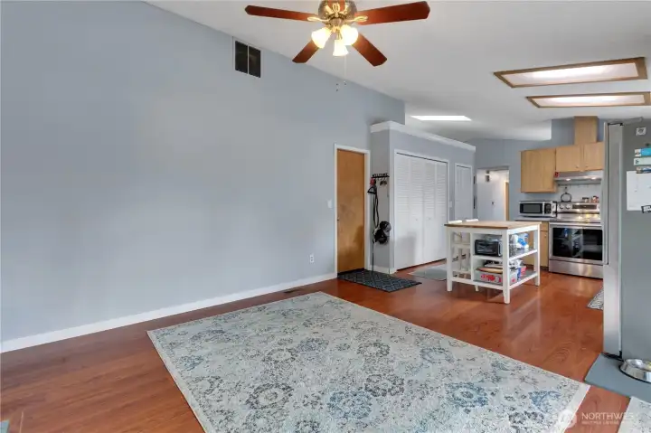This photo from the family room shows the laundry room and pantry area behind the pocket folding doors. Take note of the skylight in the ceiling in front of the doors.
