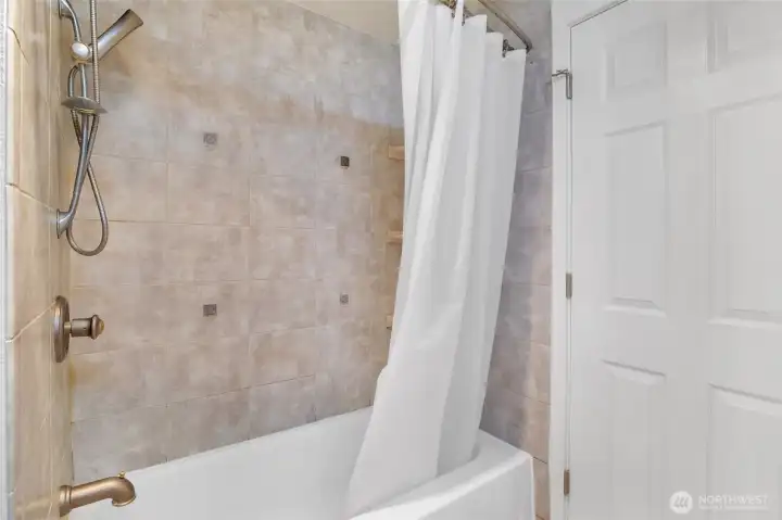 Well-designed bathroom serving the main living areas