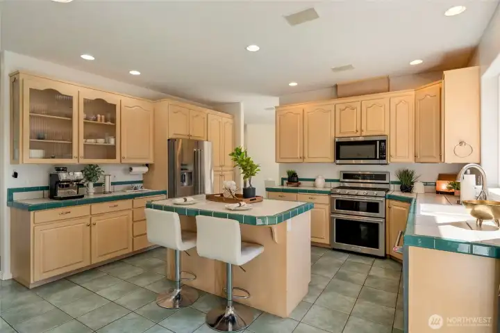 A spacious island with built-in wine fridge makes entertaining effortless and inviting.