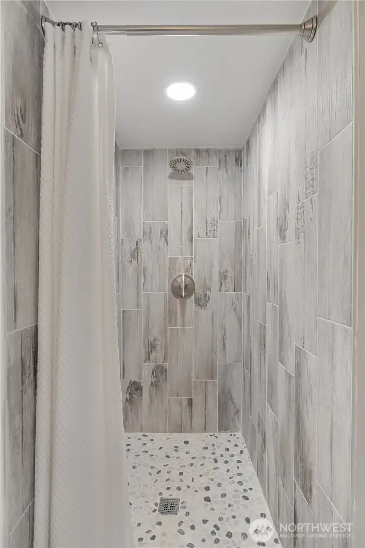 Tiled shower in 3/4 bath upstairs