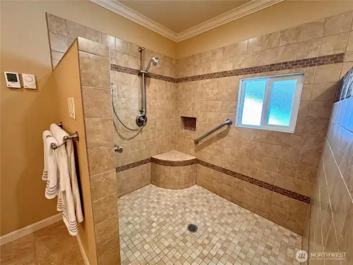 Super spacious with grab bars and seat.