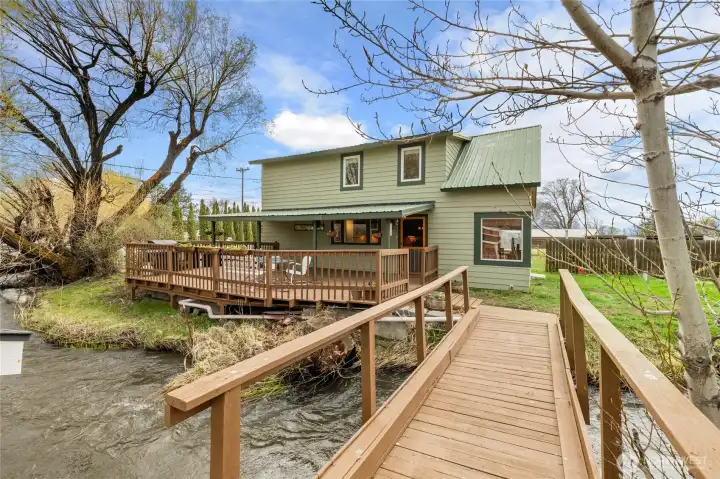 This spacious deck offers the perfect spot to relax, sip your coffee, or entertain—set against the soothing backdrop of Coleman Creek flowing through the property.
