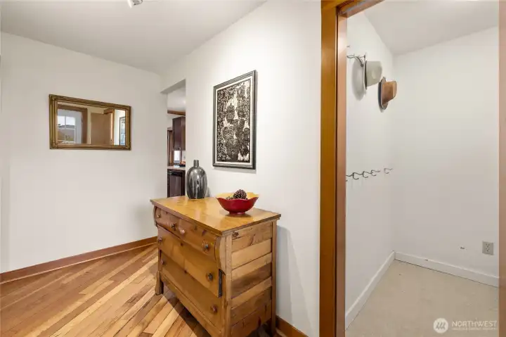 Step into the inviting entryway showcasing stunning fir floors, complemented by a spacious mudroom and ample storage for all your needs.