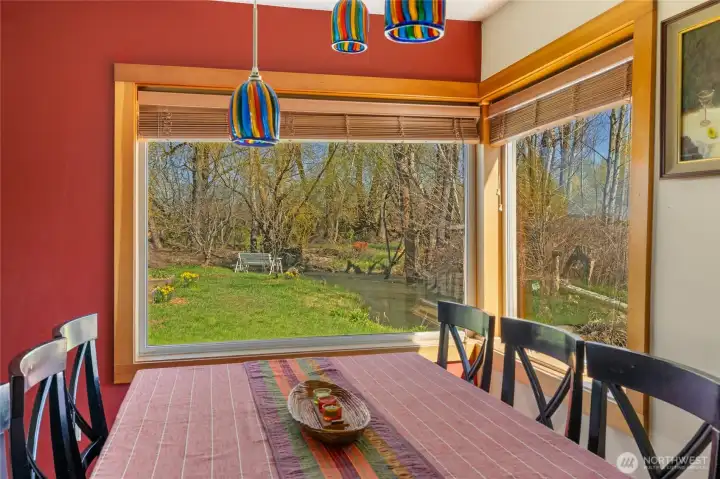 The view from the dining table is simply spectacular—overlooking Coleman Creek, vibrant flowers, and visiting wildlife.