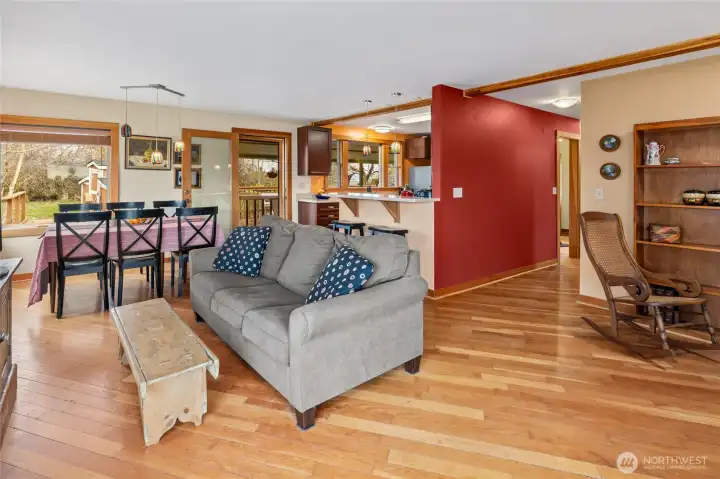A great view of the living, dining, and kitchen areas, with a picturesque view from every window.
