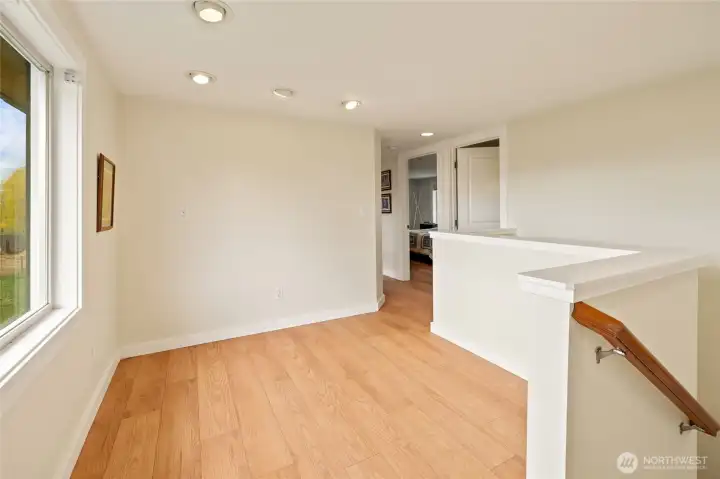 At the top of the stairs, a spacious landing area perfect for a cozy seating nook, workout space, or playroom, all with stunning views of the Stuart Mountains.