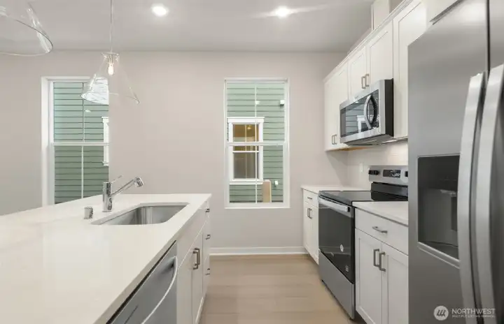 Kitchen with windows. Similar home shown. Kitchen with windows. Similar home shown.