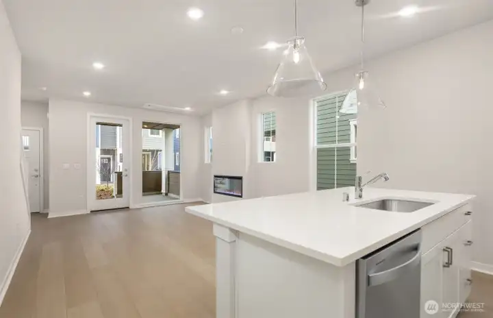 Island overlooking cafe area and gathering room. Similar home shown. Island overlooking cafe area and gathering room. Similar home shown.