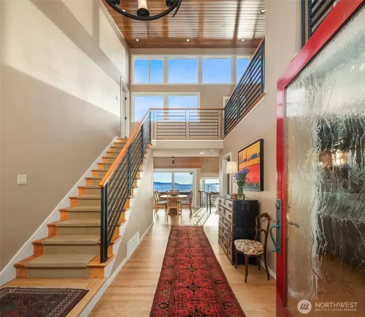Two story entry with warm wood ceilings and timeless materials. Two story entry with warm wood ceilings and timeless materials.