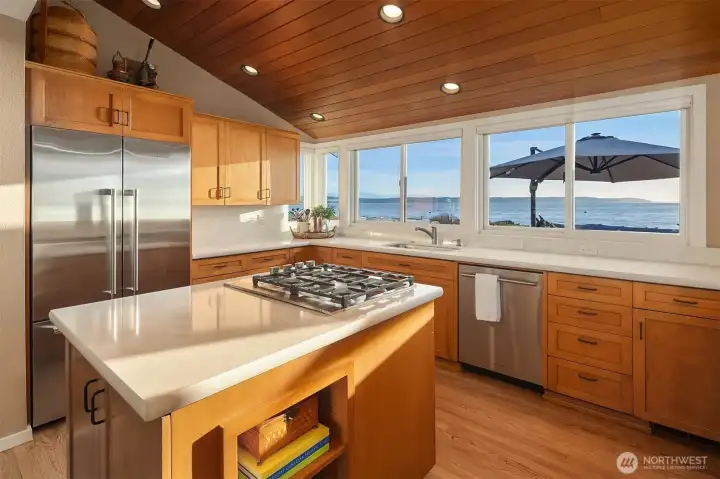 Windows frame sweeping water views with a wood ceiling that creates an elegant and inviting atmosphere. Windows frame sweeping water views with a wood ceiling that creates an elegant and inviting atmosphere.