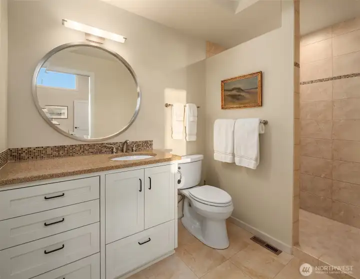 2nd ensuite bathroom with walk in shower, tile surround, and shaker cabinets with quartz countertop. 2nd ensuite bathroom with walk in shower, tile surround, and shaker cabinets with quartz countertop.