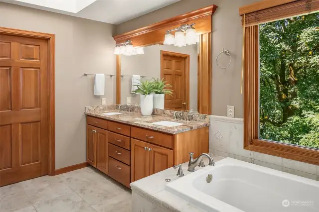 Dual vanities with the walk-in closet in the background.  Partially pictured is the skylight that provides fabulous natural light.