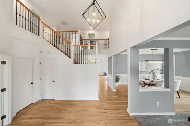 The warmth & modern feeling overwhelms guests when they walk through the front door of this stunning home. White trim work, black modern hardware, contemporary lighting - WOW