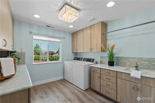 Luxurious laundry room with plenty of storage & counter space!