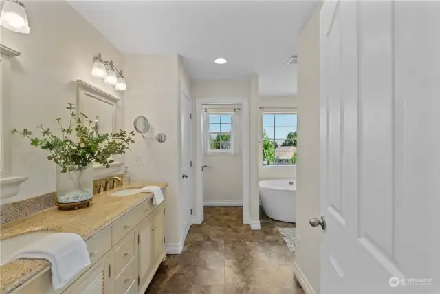 Breathtaking bathroom with double vanity, soaking tub & tile walk in shower.