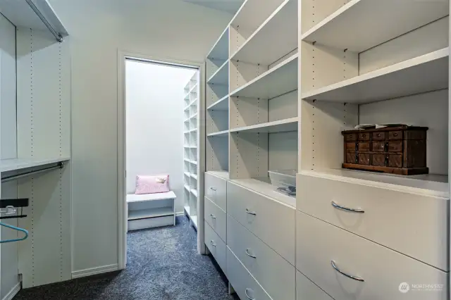 Primary Bedroom walk-in closet looking towards another space of built-in shoe/clothes storage