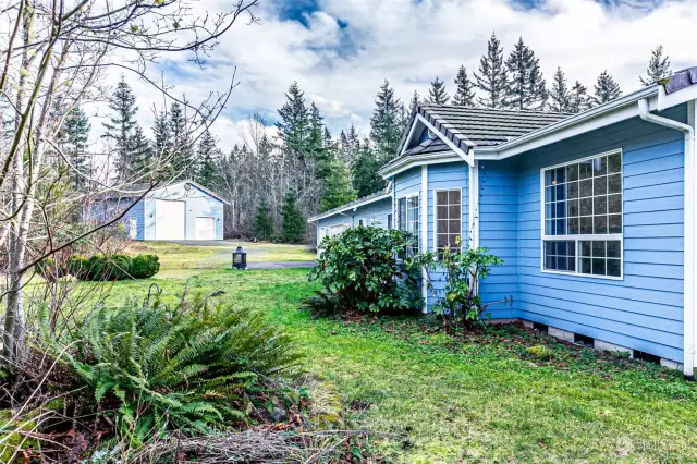 view of custom built home/garage & detached garage from property