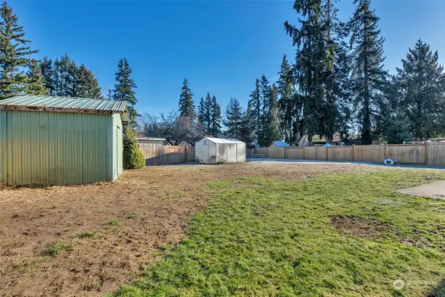 Fully fenced backyard with inground pond