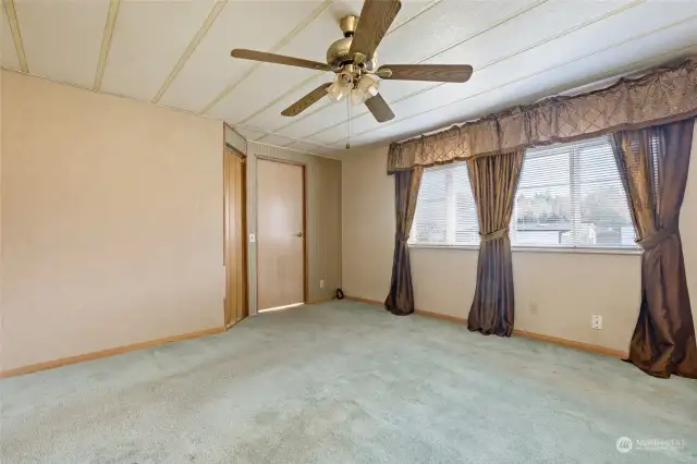 Primary bedroom facing walk-in closet and bathroom