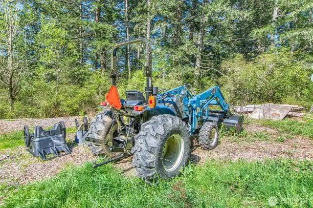 Compact utility tractor with attachments. Equipment may be available by separate negotiation.