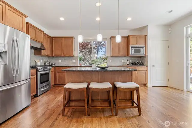 Open kitchen with slab granite top