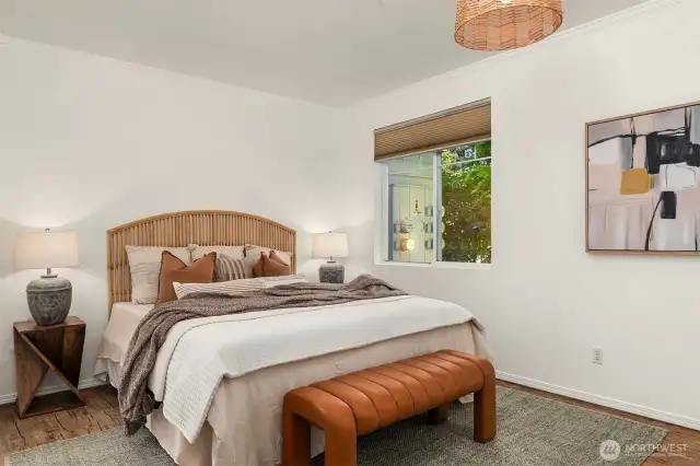 The sweet & romantic primary suite. Custom black out blinds will stay.