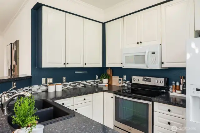 The black counters makes the white cabinets pop! But the kitchen could be easily refreshed.