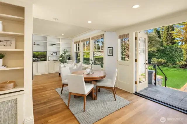 Open kitchen, breakfast and family room flow out to west facing grassy level yard, stone patio, 2 car garage off alley.