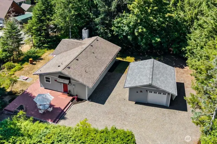 Aerial view of large corner lot and large parking area.