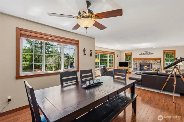 Large dining area has hardwood floors and a ceiling fan.