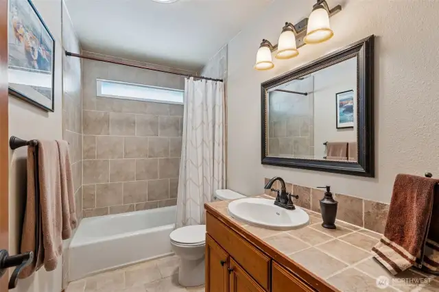 Main bath is beautifully remodeled with tile.