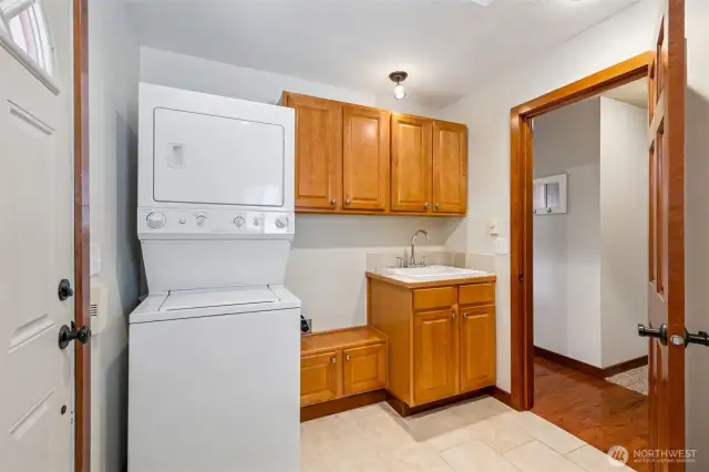 The mud room has a tile floor, washer/dryer, utility sink, closet, and lots of storage!